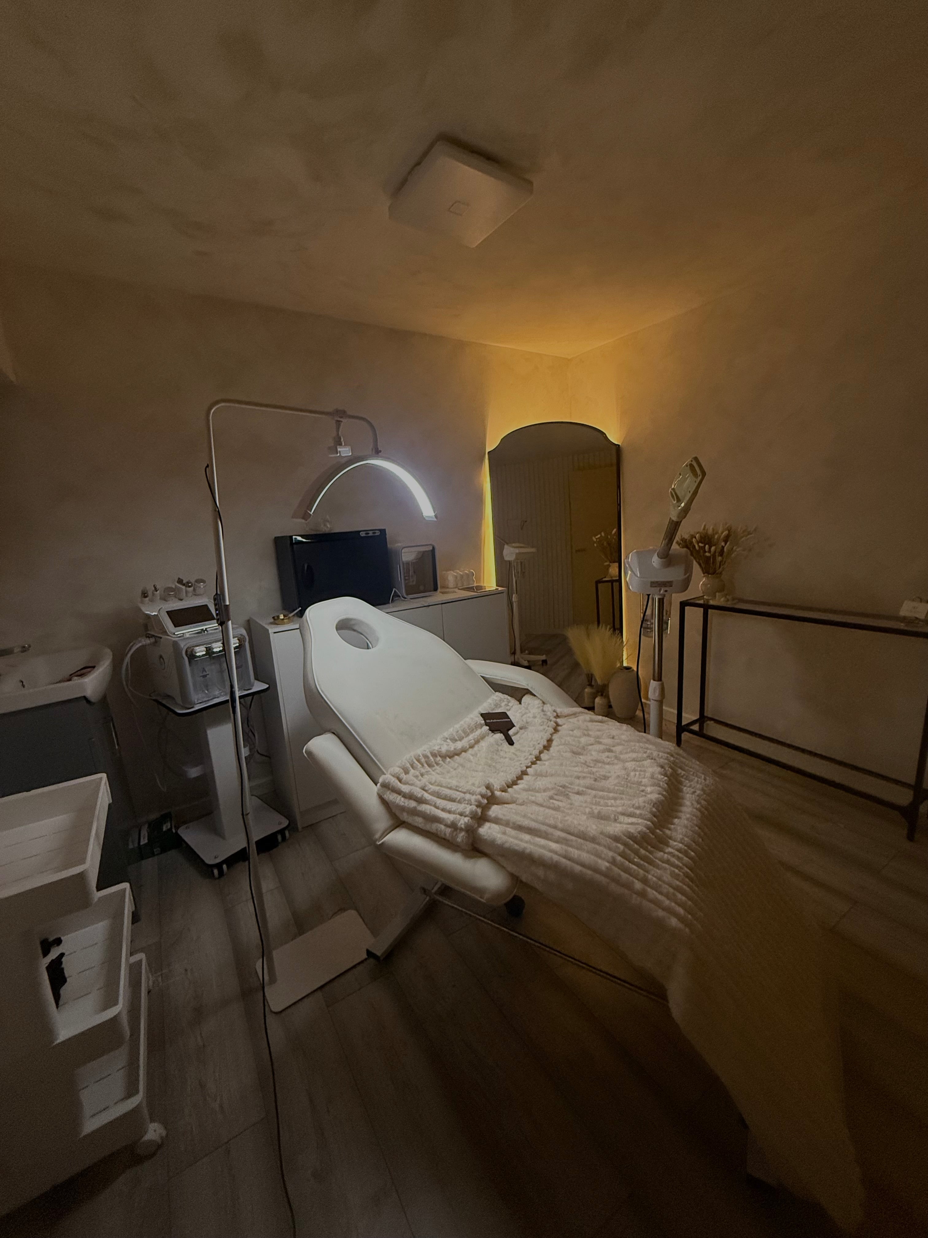 HLP Advanced Skin beauty treatment room during setup, featuring soft beige lime wash walls and professional skincare equipment
